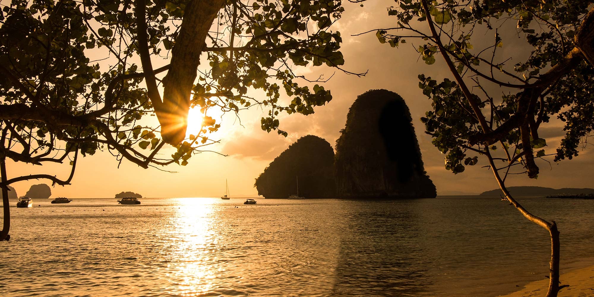 Sunset over the limestone islands and calm sea at Ao Nang, Krabi
